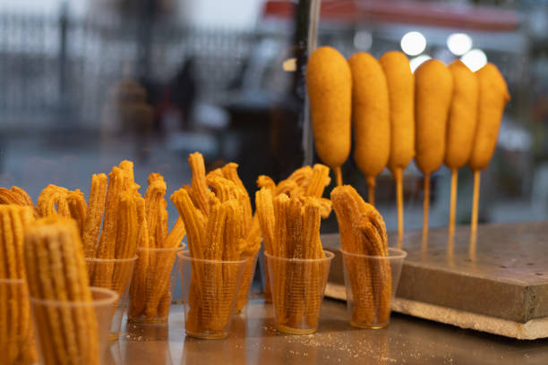 Mexican snack stand from a retail store where they sell traditional sausage banderillas or skewers and churros from a small business Horizontal photograph of a Mexican snack stand from a retail store where they sell traditional sausage banderillas or skewers and churros from a small business in the market banderilla stock pictures, royalty-free photos & images