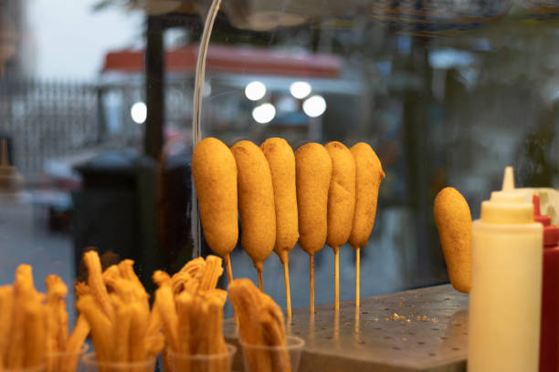 Small business that works selling Mexican snacks to its customers on the street of a tourist market of churros and banderillas Photograph of a small business that works selling Mexican snacks to its customers on the street of a tourist market where they order churros and traditional banderillas banderilla stock pictures, royalty-free photos & images