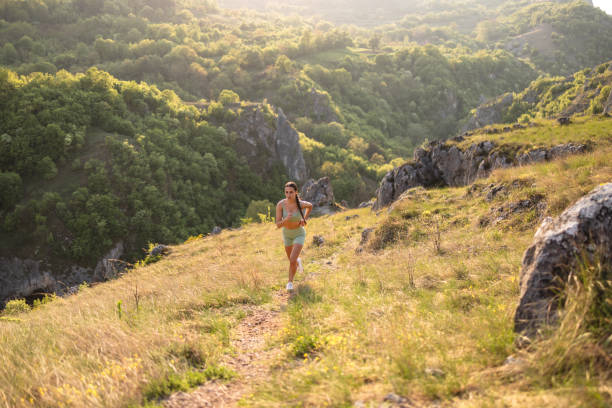 istock Active young Caucasian female runner, jogging on the mountain 2148543231