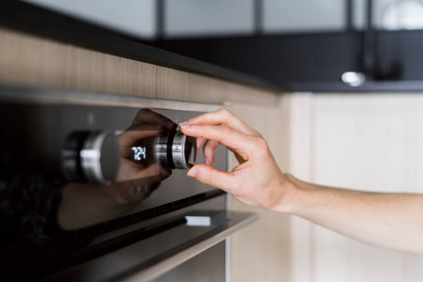 istock Woman hand regulate button, choosing microwave mode at modern oven 2148543244