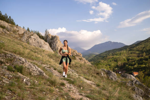 istock Active young Caucasian woman, running on the mountain 2148543275