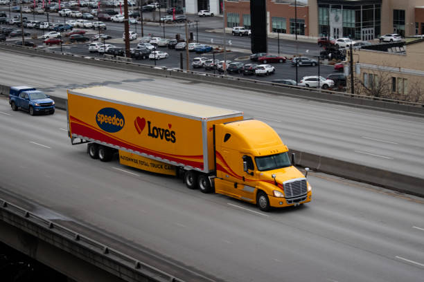 Gemini Motor Transport semi-truck eastbound on Interstate 90, passing through the downtown city center of Spokane, Washington USA.  Gemini is a member of the Love's family of companies. The most visible part of the organization is the chain of Love's branded truck stops.