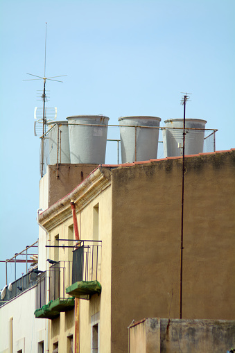 The image shows a unique combination of utility and architecture, with water tanks on the roof