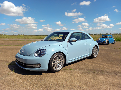 Morón, Argentina - Apr 7, 2024: Blue sport 2010s Volkswagen New Beetle two door sedan at a classic car show in an airfield. Copy space