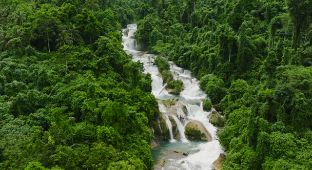 Waterfall in the tropical mountain. Aliwagwag Falls. Philippines.