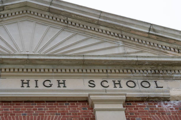 istock Example of crumbling, deteriorating ornamental precast concrete elements, features, on an old brick school building. 2148547803