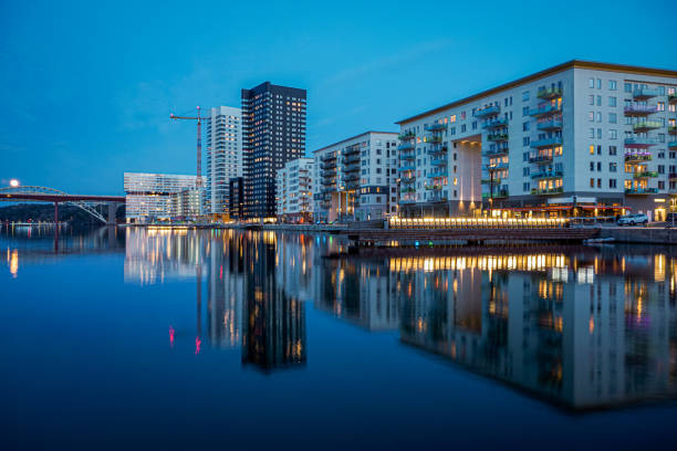 istock View of illuminated buildings by river against sky 2148548659
