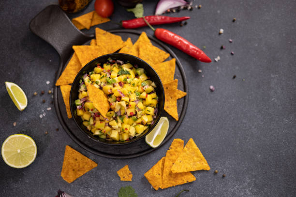 istock Freshly made mango salsa in a black ceramic bowl and nacho chips 2148548746