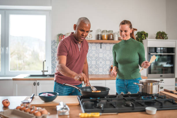 istock Mature Multi-Ethnic Couple Savors Love in the Kitchen 2148549489