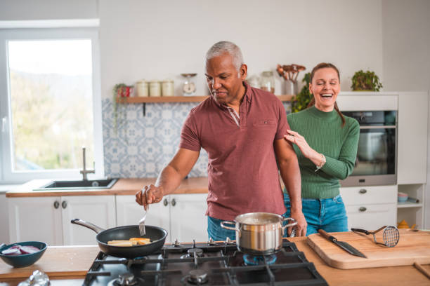 istock Lovely Mature Diverse Couple Playing In The Kitchen 2148549507