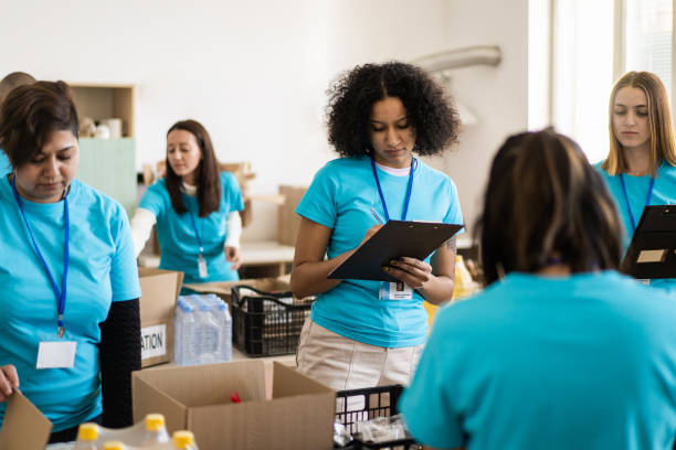 istock Volunteers sort donations during food drive 2148549529