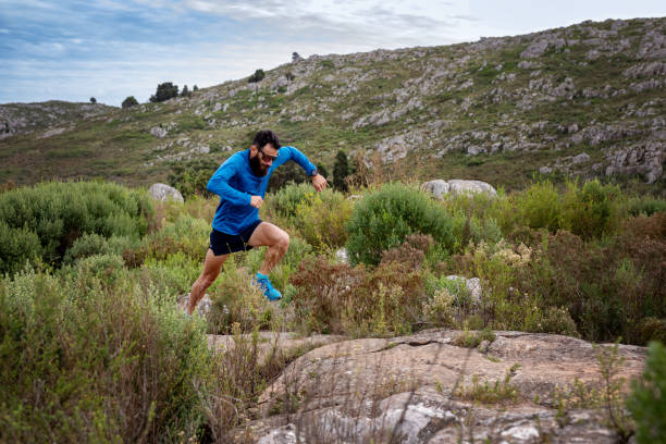 istock Young man running a race in the mountains 2148550316
