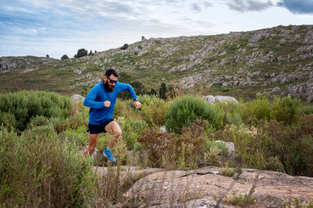 istock Young man running a race in the mountains 2148550320