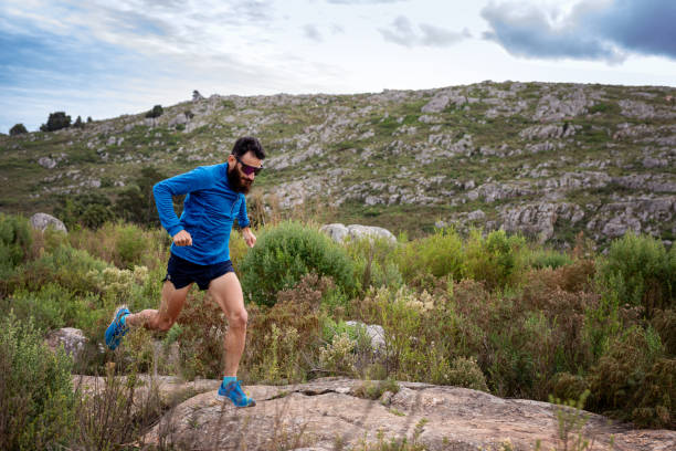 istock Young man running a race in the mountains 2148550321