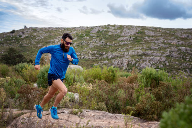 istock Young man running a race in the mountains 2148550323