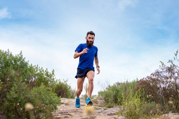 istock Young man running a race in the mountains 2148550333