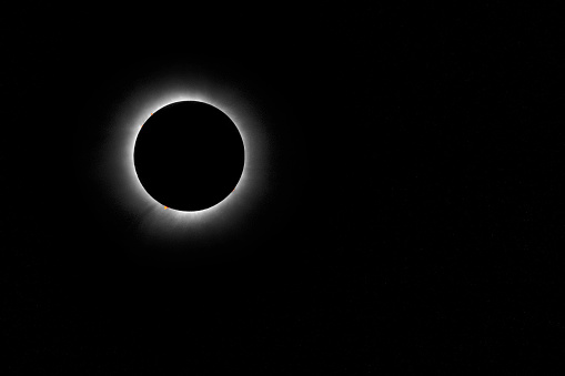 Bright light rims perimeter of the moon during a Total Solar Eclipse