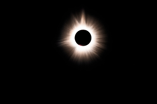 Tiny red prominences on surface of sun and hydrogen gases in the sun's atmosphere, Corona, become visible during Totality of the Total Solar Eclipse 2024, Indiana, USA
