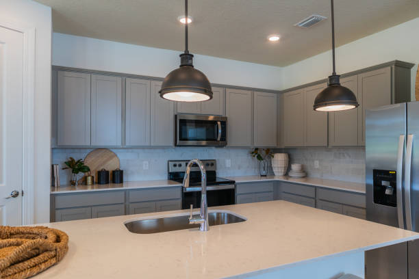 istock Gray cabinet modern kitchen with white countertops, black pendant lamps 2148550986