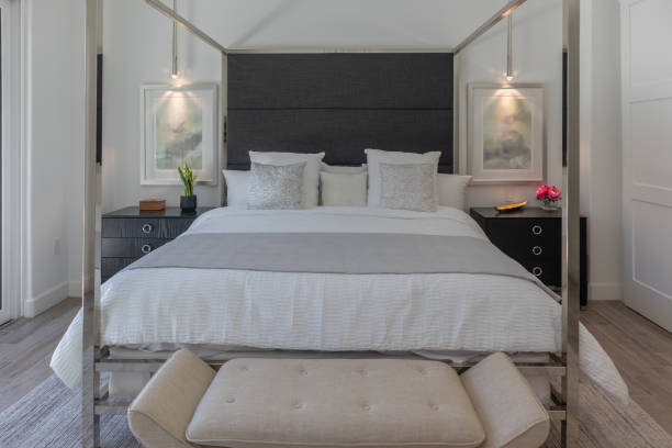 istock Front view of king size modern chrome poster bed with white comforter 2148551142