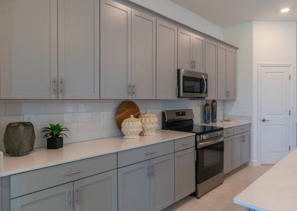 istock Side view of modern gray and white kitchen in new home 2148551167