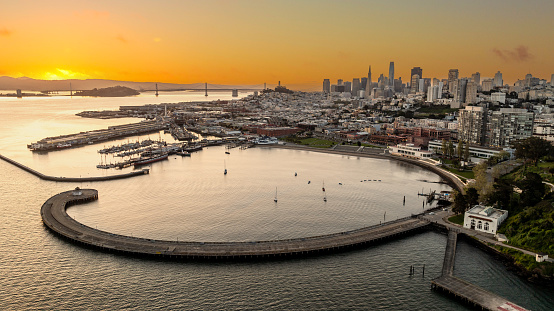 Aerial high angle view of downtown San Francisco, looking east toward Treasure Island, the San Francisco Bay Bridge and the Aquatic Park.