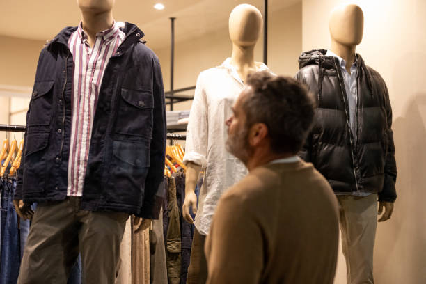 istock Man looking at the window of a clothing store 2148559787