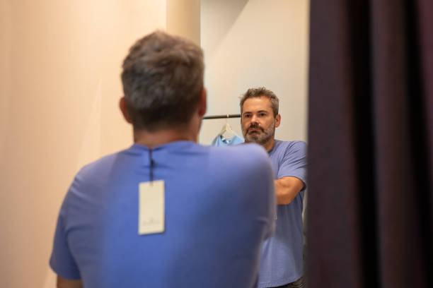istock Mature man choosing clothes in a store 2148559861