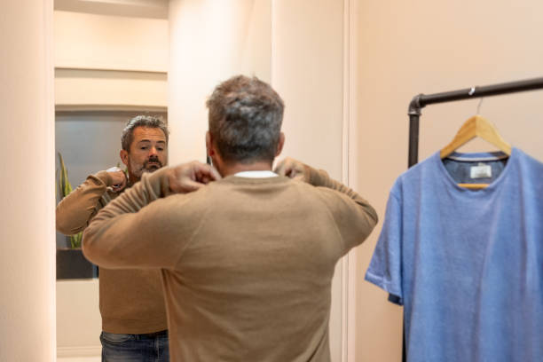 istock Mature man choosing clothes in a store 2148559888