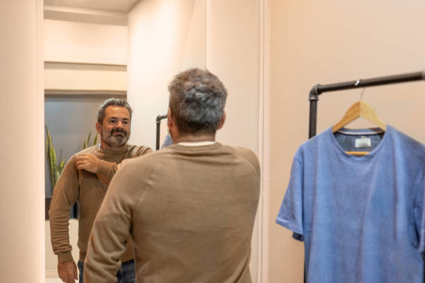 istock Mature man choosing clothes in a store 2148559889