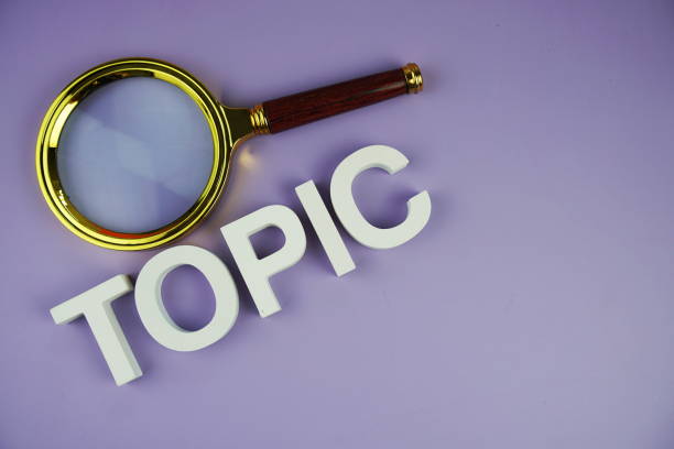 istock Topic alphabet letters with magnifying glass, business and education concept background 2148561276