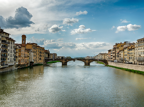 A view of the Arno River in the late afternoon looking downstream from the Ponte Vecchio bridge in Florence.