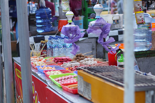 Cilacap, Indonesia - March 29, 2024 : Snacks in the form of grilled sausages, satay, grilled meatballs sold at a food festival at a local market