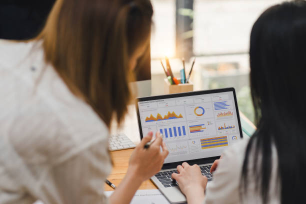 istock Two businesspeople or an accountant team are analyzing data charts, graphs, and a dashboard on a laptop screen in order to prepare a statistical report and discuss financial data in an office. 2148562710