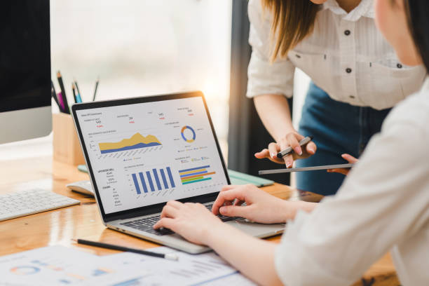 istock Two businesspeople or an accountant team are analyzing data charts, graphs, and a dashboard on a laptop screen in order to prepare a statistical report and discuss financial data in an office. 2148562723