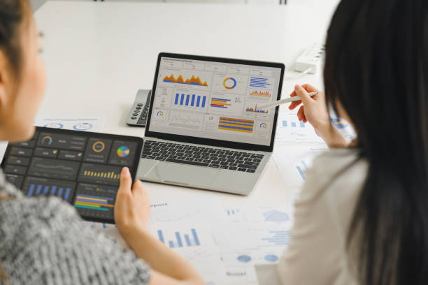 istock Two businesspeople or an accountant team are analyzing data charts, graphs, and a dashboard on a laptop screen in order to prepare a statistical report and discuss financial data in an office. 2148562748