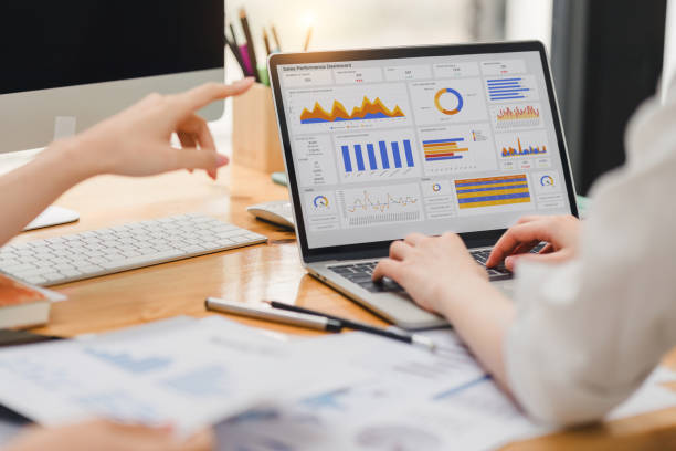 istock Two businesspeople or an accountant team are analyzing data charts, graphs, and a dashboard on a laptop screen in order to prepare a statistical report and discuss financial data in an office. 2148562821
