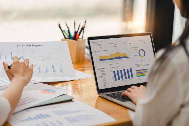 istock Two businesspeople or an accountant team are analyzing data charts, graphs, and a dashboard on a laptop screen in order to prepare a statistical report and discuss financial data in an office. 2148563140