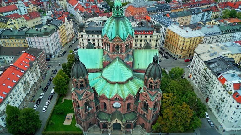 4K Aerial view Real time Footage of St. Lukas church river side with road traffic in Munich, Bavaria, Germany, Europe, Famous Landmarks and Travel Destination Concept,