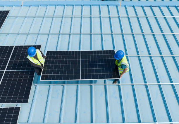 istock Workers carry solar panels on the roof 2148566855