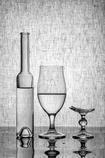 Still life with glassware and a broken glass