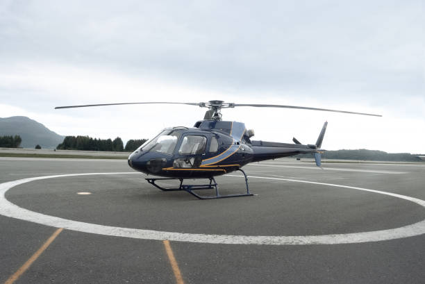 istock Blue and Orange Helicopter on Runway in Forested Area 2148569931