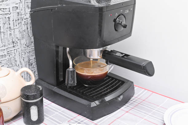 istock A coffee maker pours coffee into a glass cup in the kitchen 2148570969