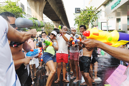 Bangkok, Thailand - April 13, 2024 : Songkran world biggest water festival. People around the world come travel most popular water fight with water gun on famous Songkran thai new year at Silom road.
