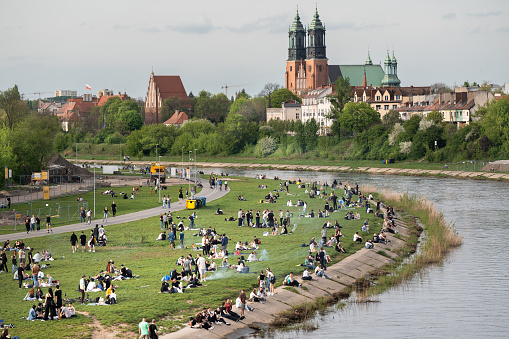 Poznan, Greater Poland, Poland, Mpril 14, 2024. Students and residents of Pozna barbecuing on the banks of the Warta River. Pozna Cathedral in the background