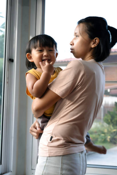 istock Mother Holding Her Baby Boy 2148572419