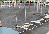 Children Playground with Modern Slide, Rope Net Bridge, Climbing Swings, Climbers. Empty Wooden Playground made of Eco Materials