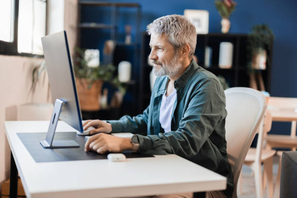 istock Mature man working at his home office 2148573037