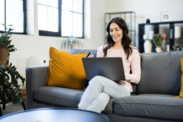 istock Happy woman banking from her sofa 2148573062