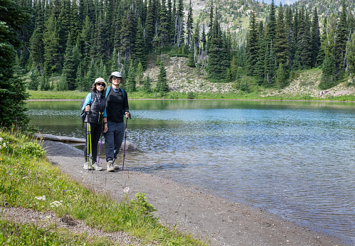 Couple hiking Shadow Lake Trail. Sunrise area. Mount Rainier National Park. Washington State.